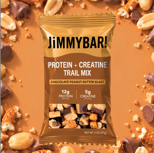A bag of JimmyBar! Protein + Creatine Trail Mix, Chocolate Peanut Butter Blast flavor, shown against a warm brown background scattered with peanuts, chocolate pieces, and crumbs.