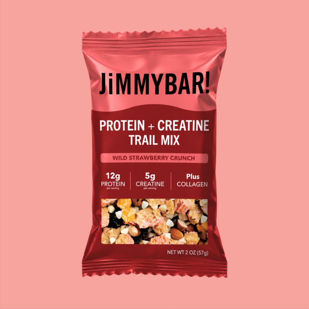 A package of JimmyBar! Protein + Creatine Trail Mix in Wild Strawberry Crunch flavor, shown against a solid pink background.